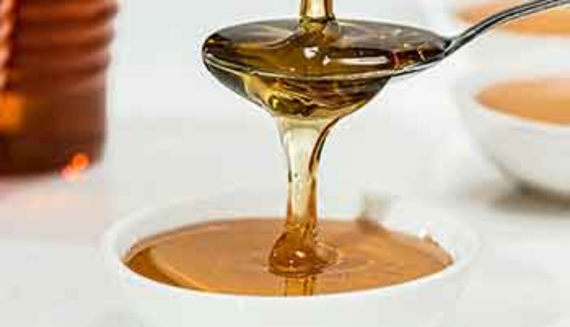 maple syrup being poured into spoon and bowl