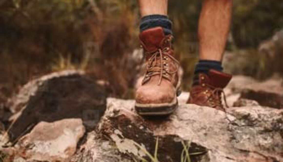 closeup of feet hiking over rocks
