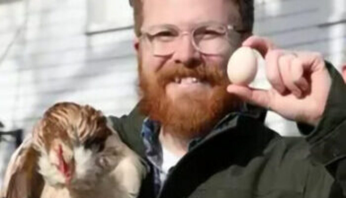 Man holiding chicken and egg