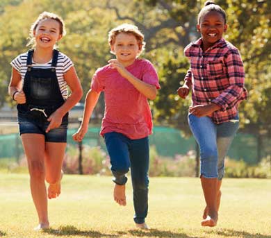 group of mixed racial children playing in snow